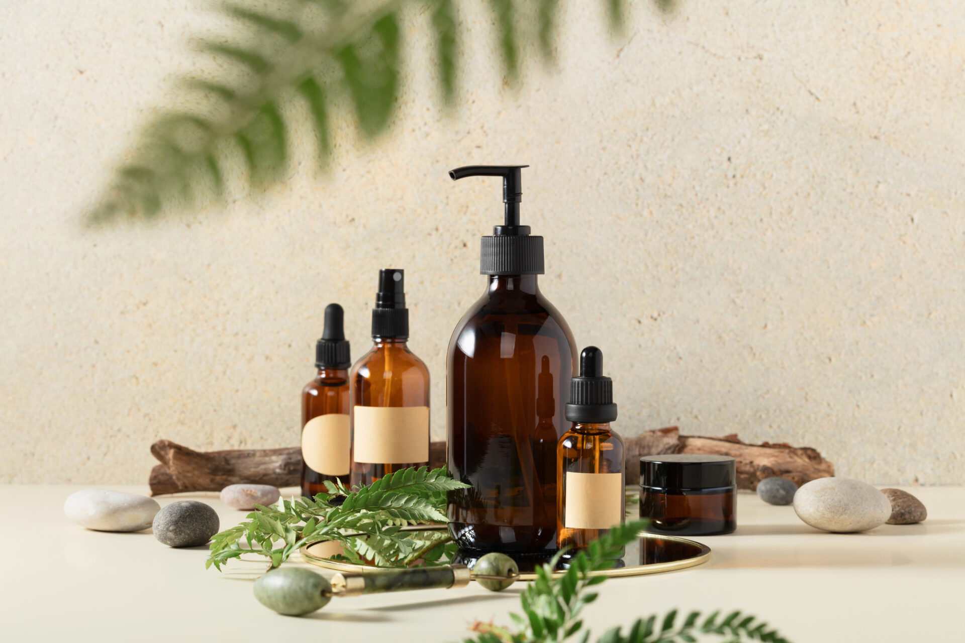 Amber glass bottles on beige background. Soap liquid, shampoo or